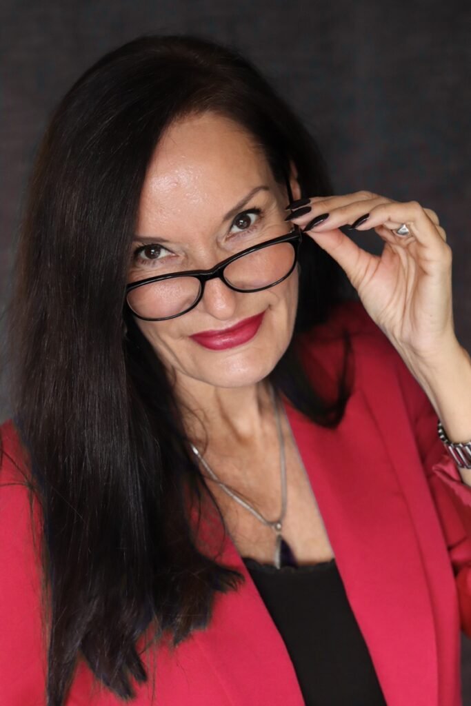 Aglaia wearing a red blazer and red lipstick illustrating the power of red in personal style